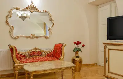 a living room with a chair and a mirror at Boutique Hotel Green Lobster in Prague