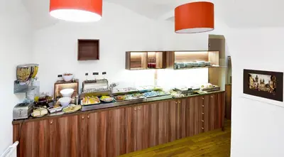 a kitchen with a buffet line with food at Boutique Hotel Green Lobster in Prague