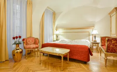 a hotel room with a bed and two chairs at Boutique Hotel Green Lobster in Prague