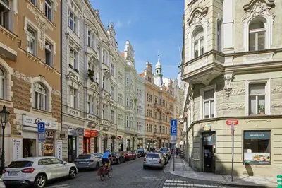 a city street with parked cars and buildings at Prague Days - Apartment with Balcony and Amazing View in the Old Town in Prague