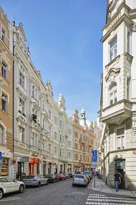 a city street with buildings and cars parked on the street at Prague Days - Apartment with Balcony and Amazing View in the Old Town in Prague