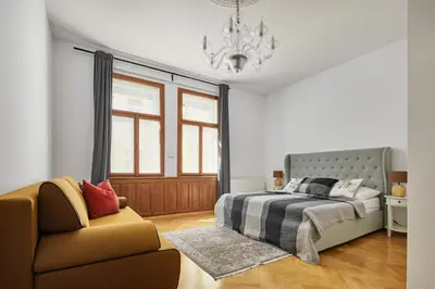 a bathroom with a sink and a tub and a mirror at Prague Days - Apartment with Balcony and Amazing View in the Old Town in Prague