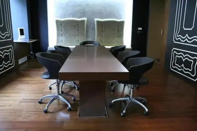 a conference room with a wooden table and chairs at 987 Design Prague Hotel in Prague