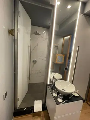 a bathroom with a sink and a shower with a mirror at 987 Design Prague Hotel in Prague