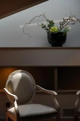 a chair sitting under a table with a plant on it at 987 Design Prague Hotel in Prague