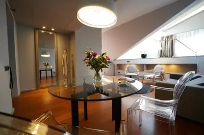 a living room with a glass table with flowers on it at 987 Design Prague Hotel in Prague
