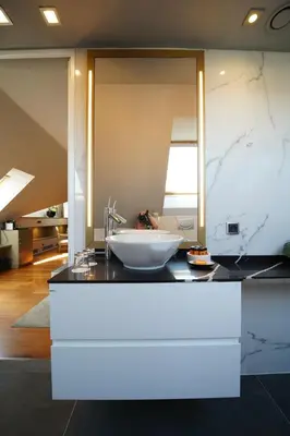 a bathroom with a sink and a large mirror at 987 Design Prague Hotel in Prague