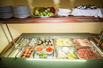 a refrigerator filled with lots of different types of food at Hotel City Bell in Prague