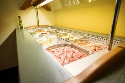 a buffet line with many different types of food at Hotel City Bell in Prague