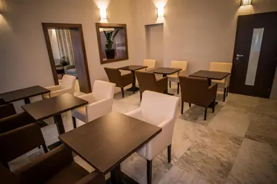 a restaurant with tables and chairs in a room at Hotel City Bell in Prague