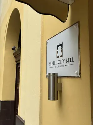 a sign on the side of a building at Hotel City Bell in Prague