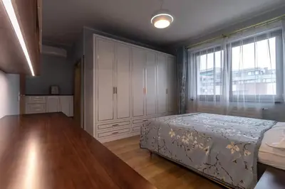 a bedroom with a bed and a large window at yipin villa in Prague