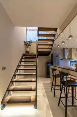 a spiral staircase in a kitchen with a table and chairs at yipin villa in Prague