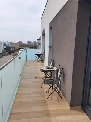 a balcony with chairs and a table on a building at yipin villa in Prague