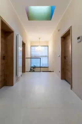 a large empty room with a large window and a ceiling at yipin villa in Prague