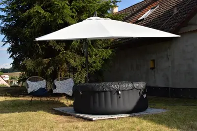 an umbrella and two chairs under a table at Bohemica Apartman 3 in Kouřim