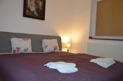 a bed with two towels on top of it at Bohemica Apartman 3 in Kouřim