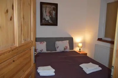a bedroom with a bed with two towels on it at Bohemica Apartman 3 in Kouřim