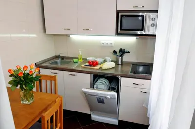 a small kitchen with a table and a microwave at Pension Prague City in Prague