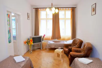 a living room with a couch and a tv at Pension Prague City in Prague
