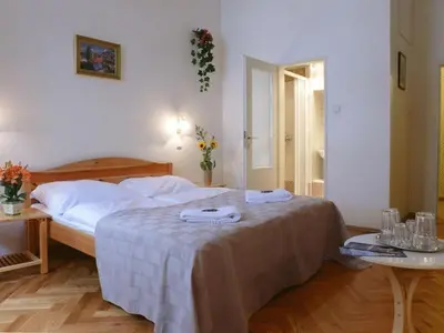 a bedroom with a bed with two towels on it at Pension Prague City in Prague