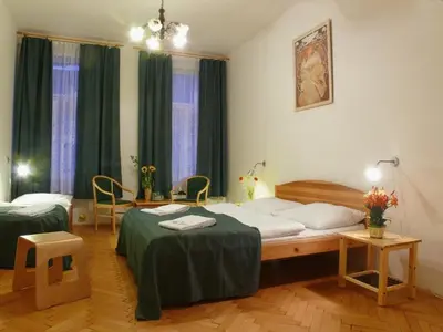 a hotel room with two beds and two chairs at Pension Prague City in Prague