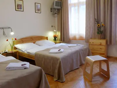 a hotel room with two beds with towels on them at Pension Prague City in Prague