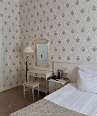 a bedroom with a bed and a desk and a mirror at Hotel Rott in Prague