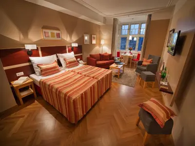 a library with couches and a christmas tree in it at EA Hotel Julis in Prague