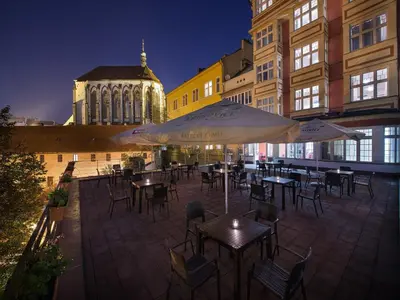 a table with a plate of food and drinks on a patio at EA Hotel Julis in Prague