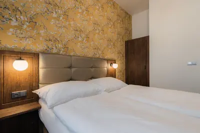 a bedroom with a bed with a painting on the wall at EA Hotel Victoria in Prague