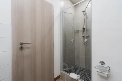 a bathroom with a shower with a glass door at EA Hotel Victoria in Prague