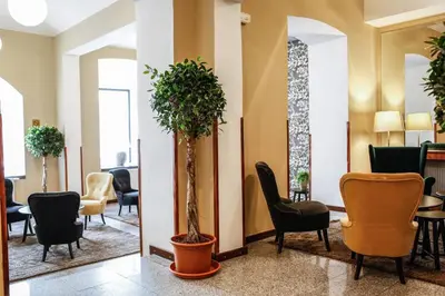 a waiting room at a hospital with chairs and plants at EA Hotel Victoria in Prague