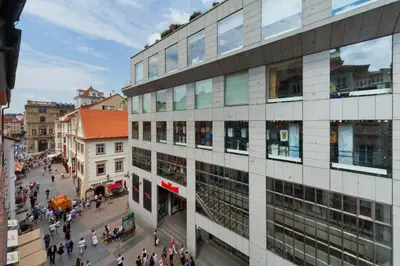 a group of people walking around a building at Prague Inn in Prague
