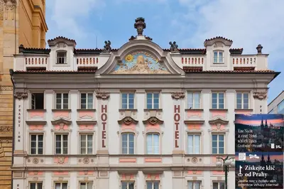 a building with a clock on the top of it at Prague Inn in Prague
