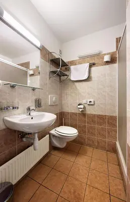 a bathroom with a toilet and a sink at Hotel Golden City Garni in Prague