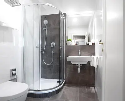 a bathroom with a shower and a sink at Hotel Schwaiger in Prague