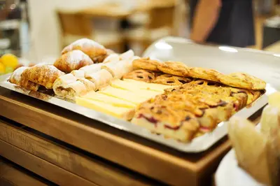 a tray of pastries and breads on a table at Hotel Schwaiger in Prague