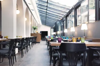 a row of tables and chairs in a restaurant at Hotel Schwaiger in Prague