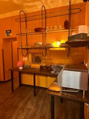 a kitchen with a counter with a table and a shelf at Gallery Hotel SIS in Prague