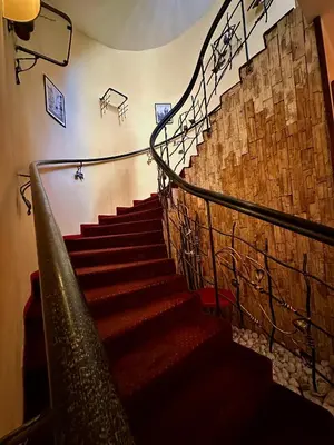 a spiral staircase in a building with a stone wall at Gallery Hotel SIS in Prague