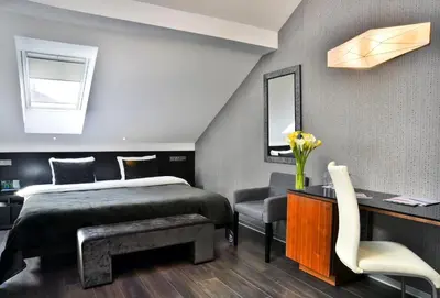 a bedroom with a bed and a desk and a chair at Ametyst Hotel Praha in Prague