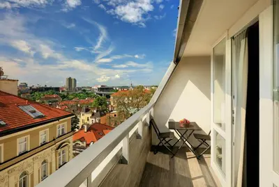 a balcony with a table and a view of the city at Ametyst Hotel Praha in Prague