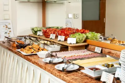 a buffet of food on a counter with food at Ametyst Hotel Praha in Prague