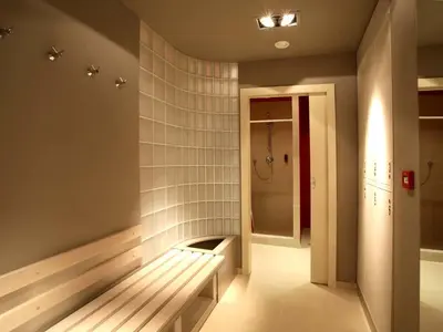 a bathroom with a bench and a walk in shower at EA Hotel Crystal Palace in Prague