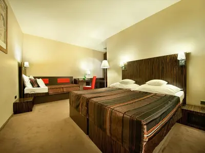 a hotel room with a large bed and a chair at EA Hotel Crystal Palace in Prague