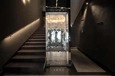 a staircase with a glass elevator in a building at THE MANES Boutique Hotel Prague in Prague