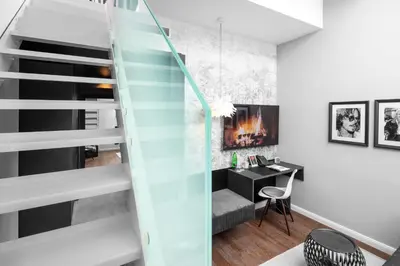 a glass staircase in a room with a desk at THE MANES Boutique Hotel Prague in Prague