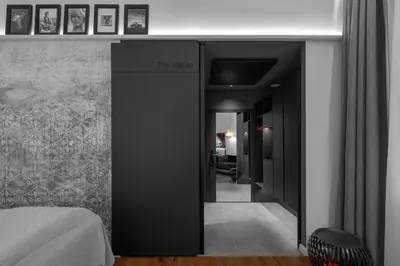 a bedroom with black walls and a room with a bed at THE MANES Boutique Hotel Prague in Prague