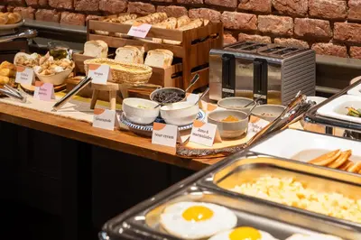 a buffet with eggs and other food on a table at THE MANES Boutique Hotel Prague in Prague